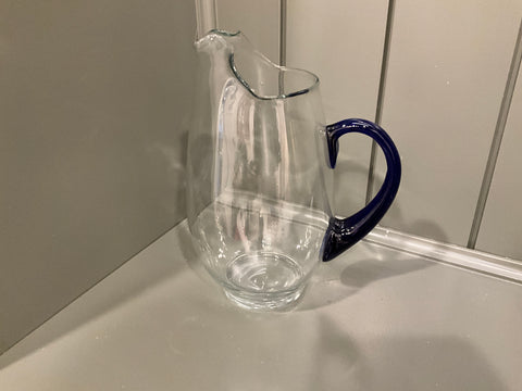 Glass pitcher with blue handle